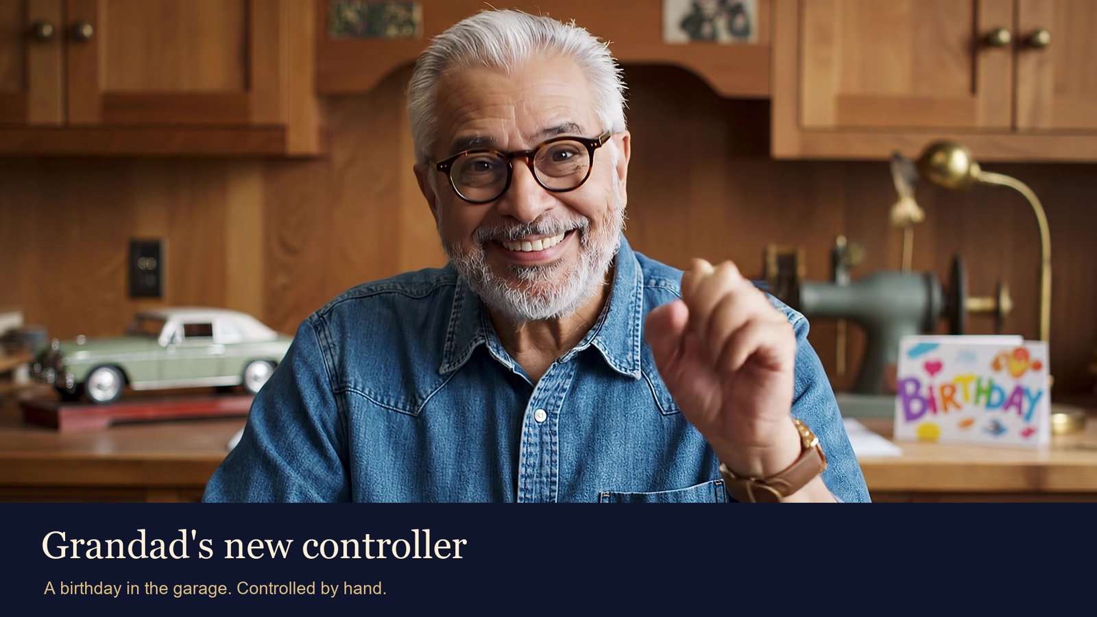 Fictional grandfather Arthur smiling at his laptop in a warm workshop